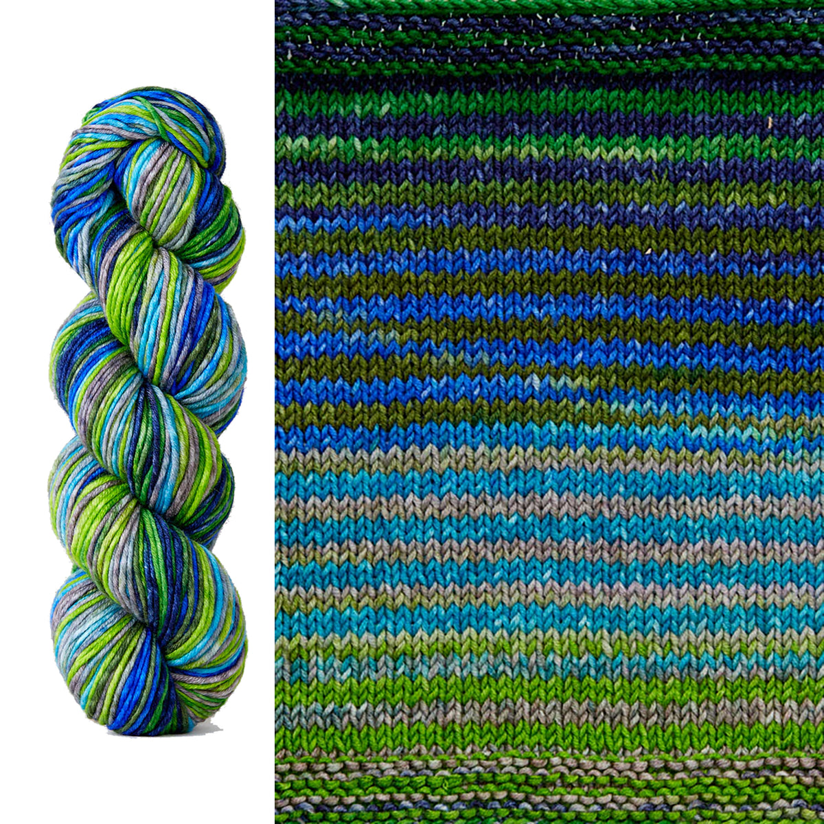 A skein and swatch of Urth Uneek Worsted 4025, a self striping yarn in forest green, lime green, medium green, denim blue, electric blue, sky blue, and light grey.