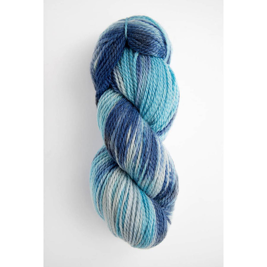 A skein of Amano Rita in variegated dark blue, sky blue, and white