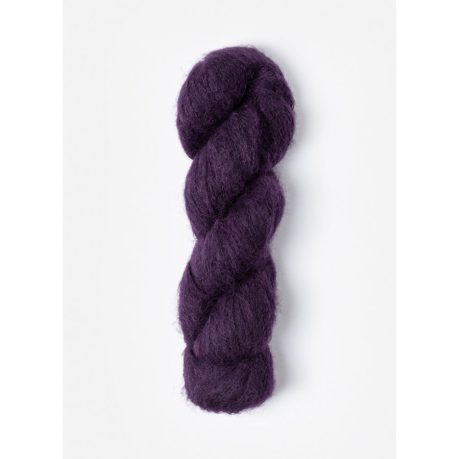 A skein of Blue Sky Fibers Prairie in Elderberry, a dark purple