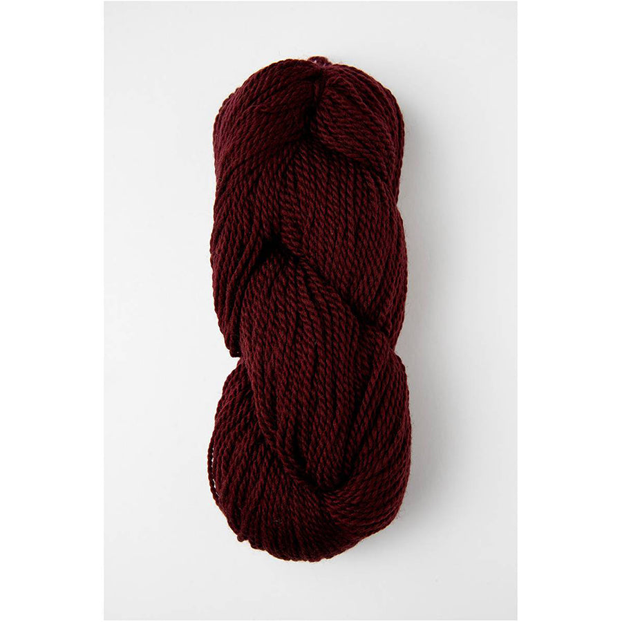 A skein of Amano Riti Garnet Rock in a deep wine red