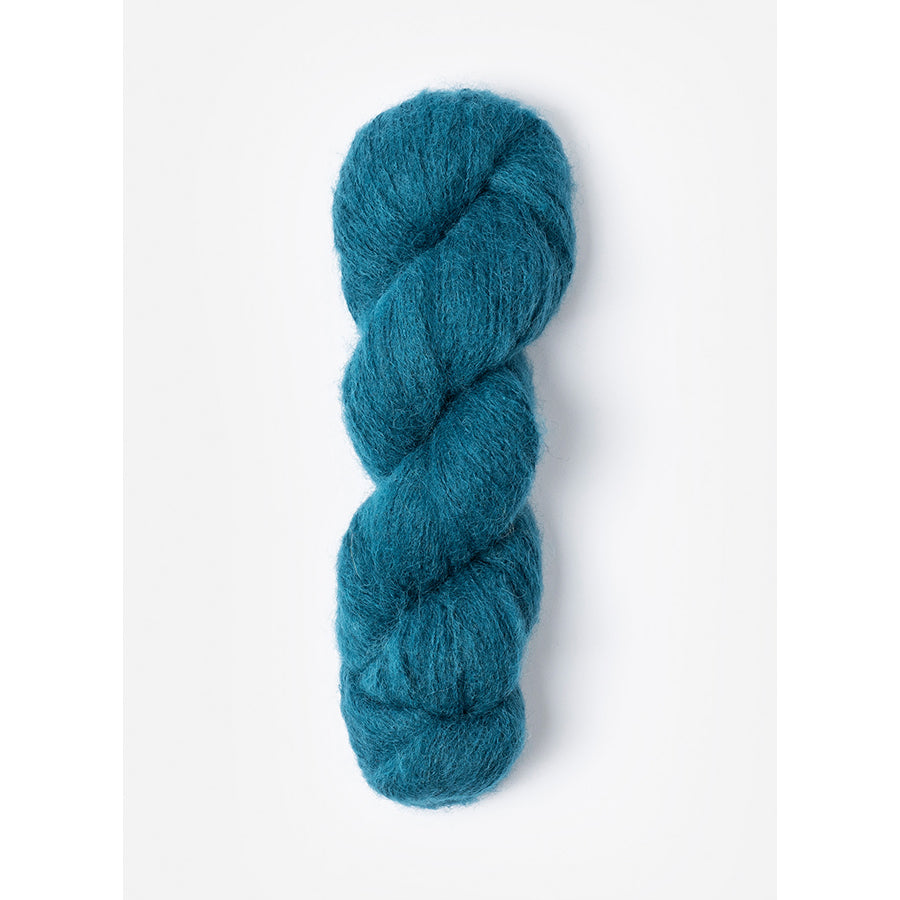 A skein of Blue Sky Fibers Prairie in Juniper, a dark teal