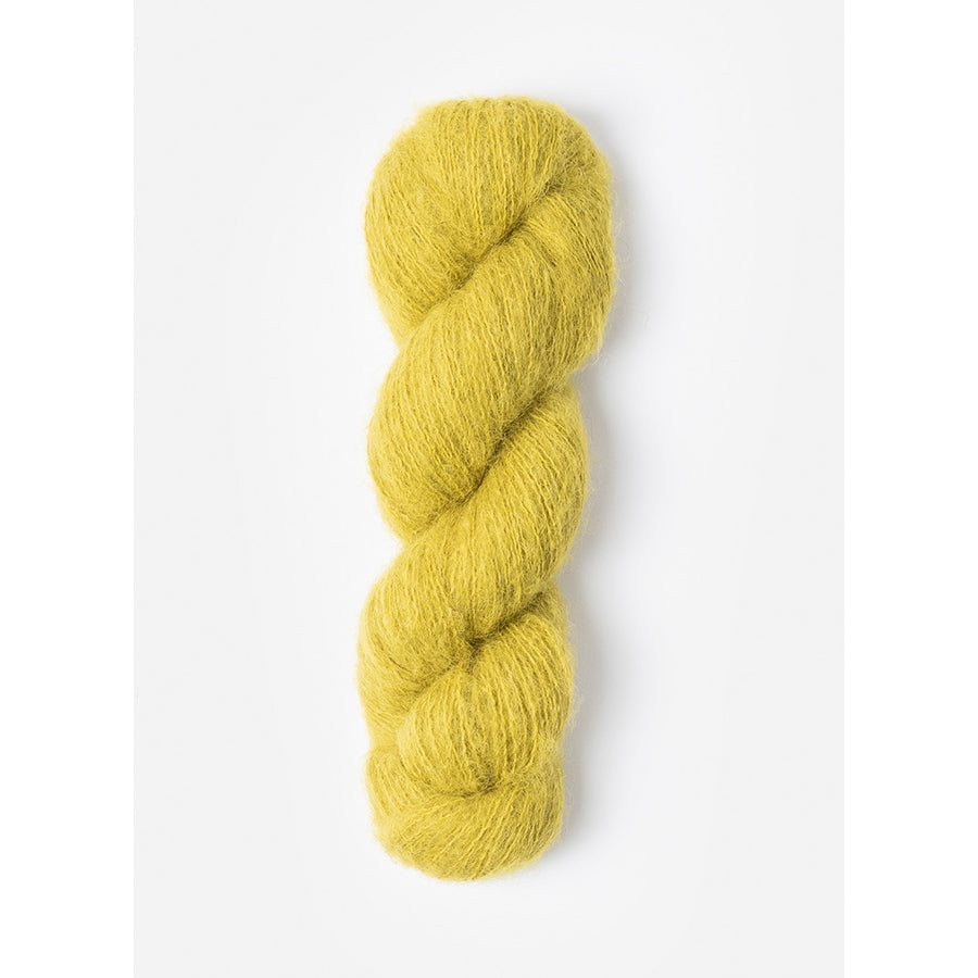 A skein of Blue Sky Fibers Prairie in Katydid, a light yellowish green 