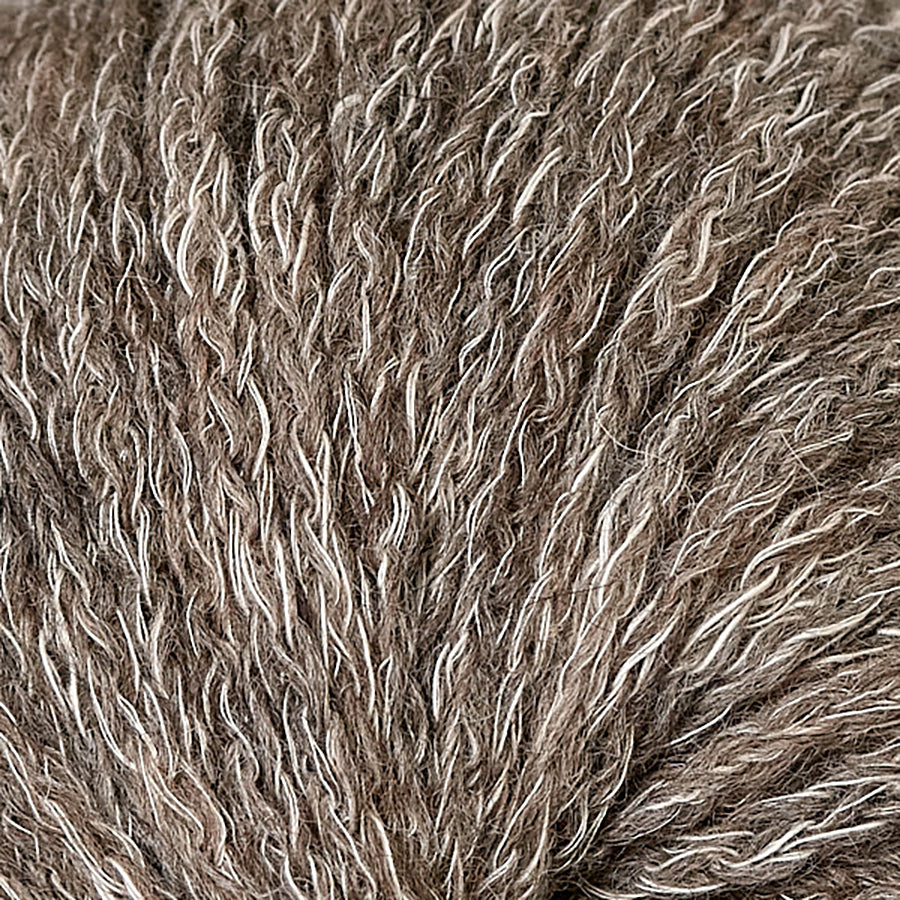 Closeup of Berroco Hearthside Kona, a dark chocolate brown and cream color.