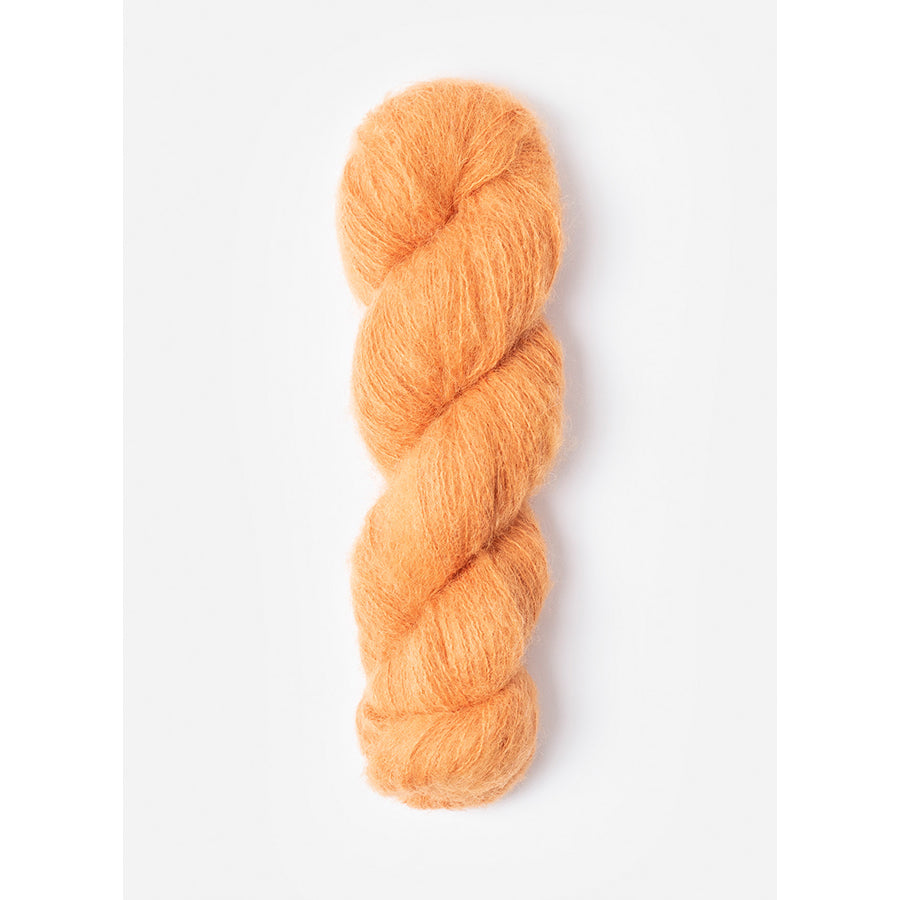 A skein of Blue Sky Fibers Prairie in Monarch, a pale orange