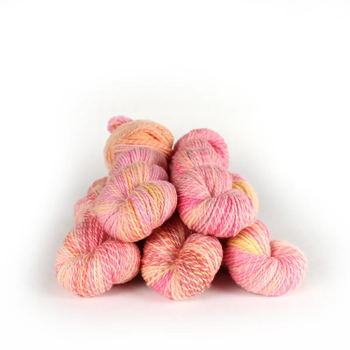 Five skeins of JFM Making Tracks Pinky Swear, variegated light pinks and yellows