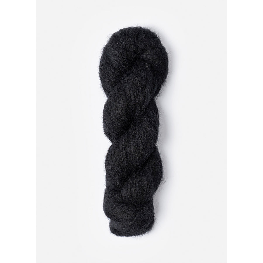 A skein of Blue Sky Fibers Prairie in Raven, a black color