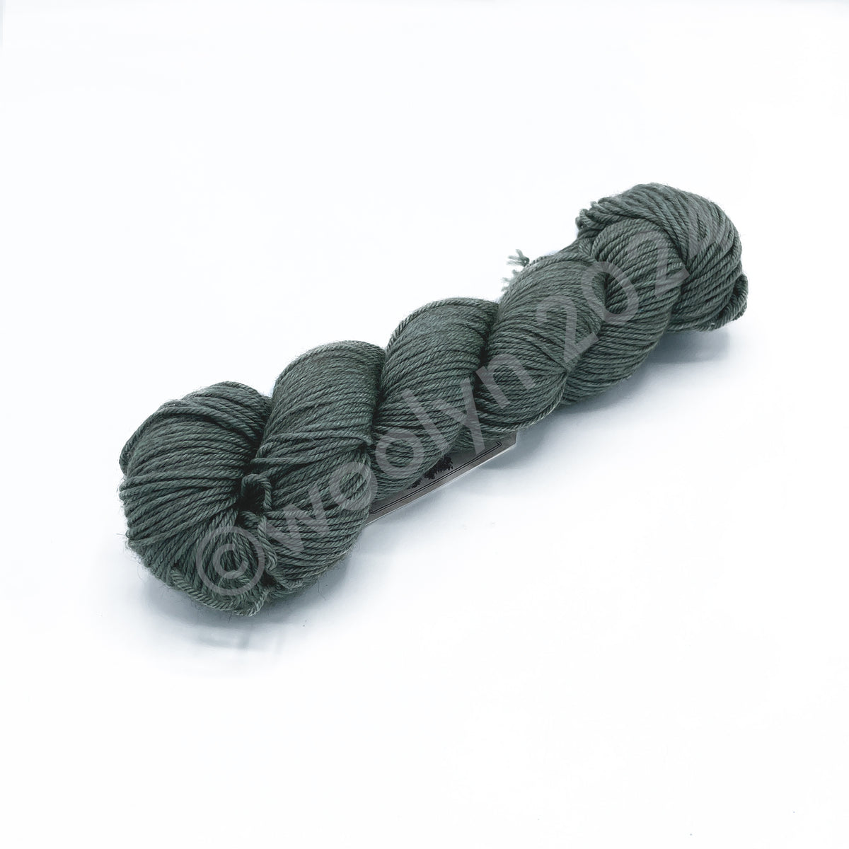 A skein of Woolerton Estates Distinguished Rita, a pale minty green with deep grey undertones.