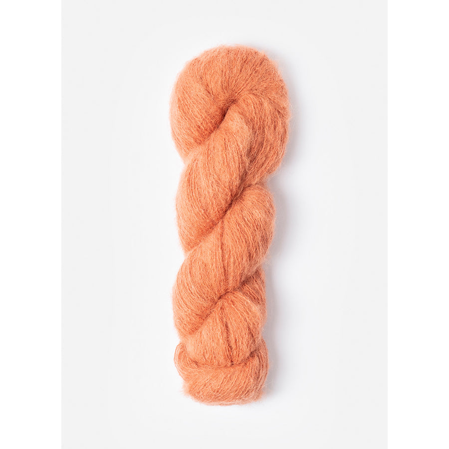 A skein of Blue Sky Fibers Prairie in Sedum, a peachy orange