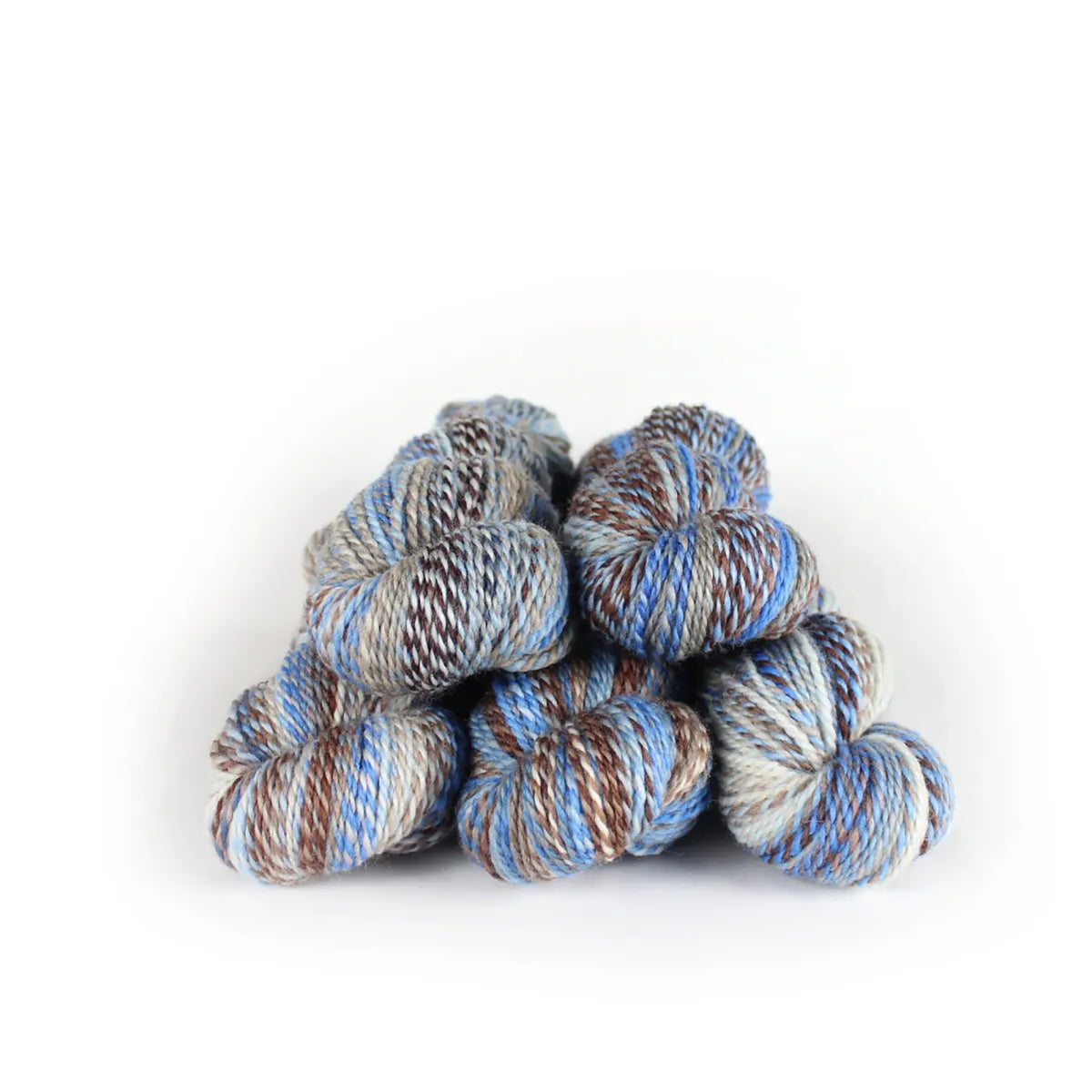 Five skeins of JFM Making Tracks Stick Season, variegated brown, beige, and light blue