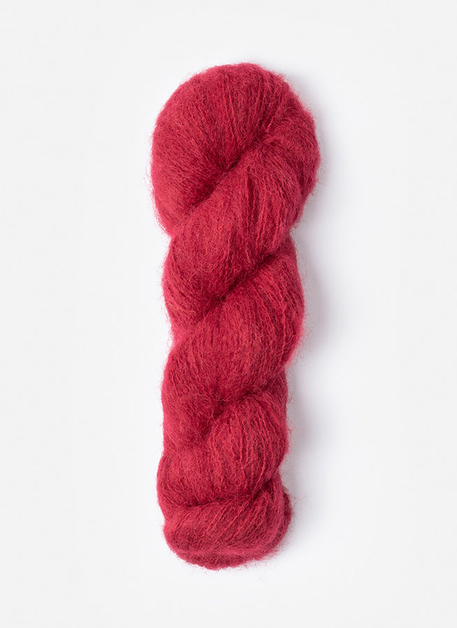 A skein of Blue Sky Fibers Prairie in Sumac, a rich red 