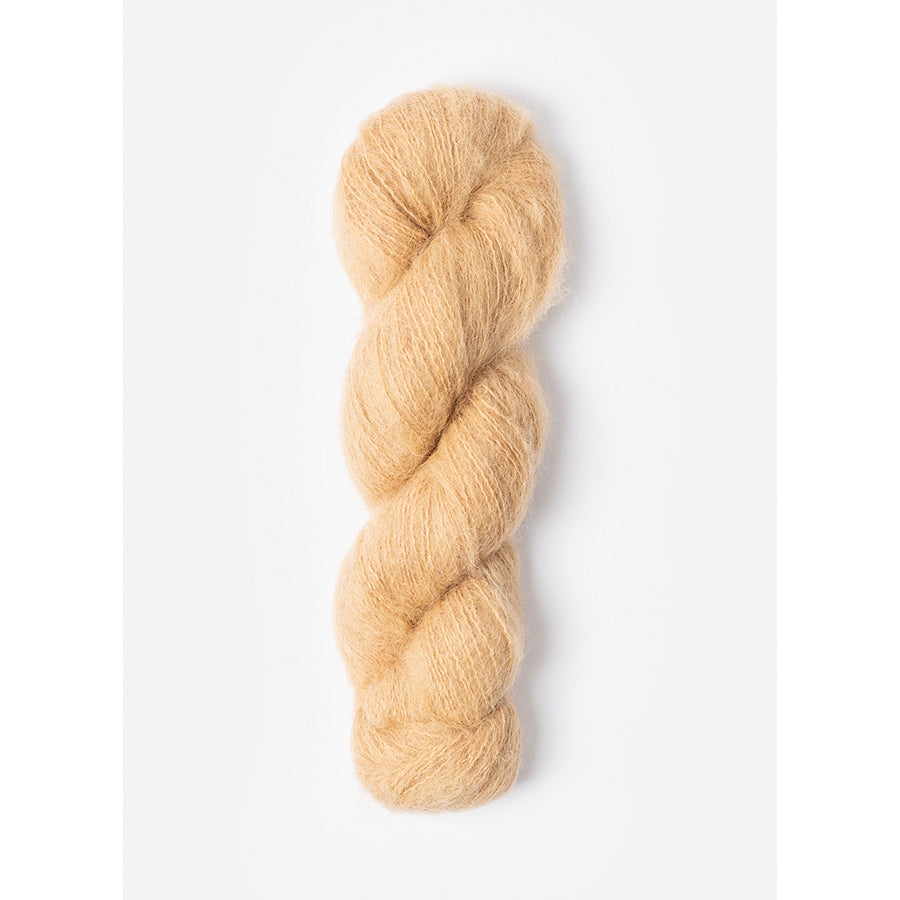 A skein of Blue Sky Fibers Prairie in switchgrass, a sand color