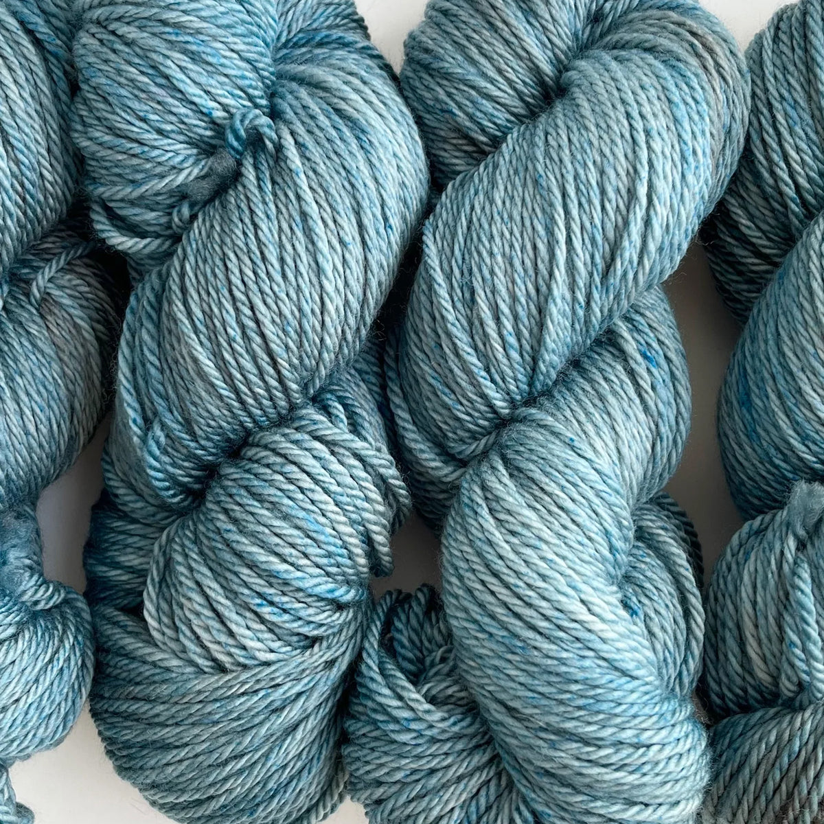 Skeins of Tributary Tidal DK Tributary, a tonal light greyish blue