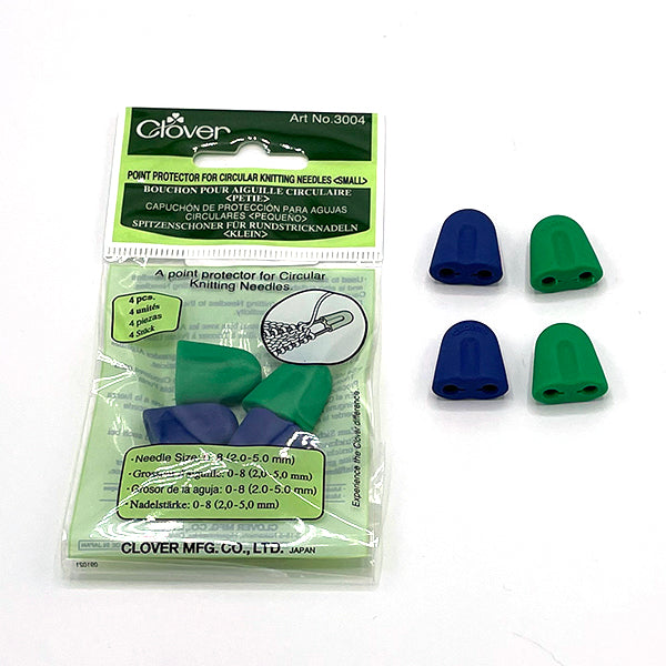 A package of 4 small circular point protectors, two green and two blue