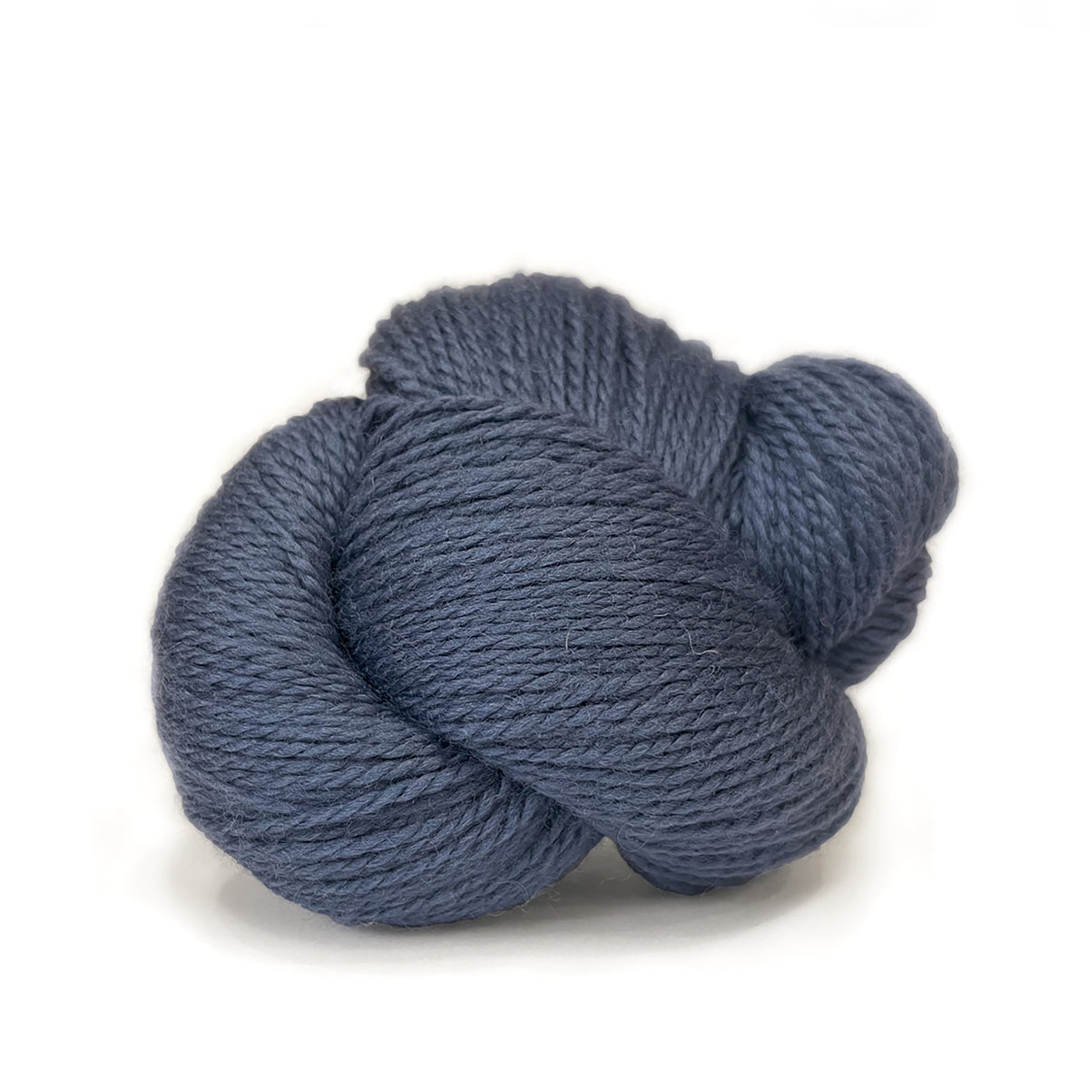 A skein of Kelbourne Woolens Scout Denim 423, a greyish blue with hints