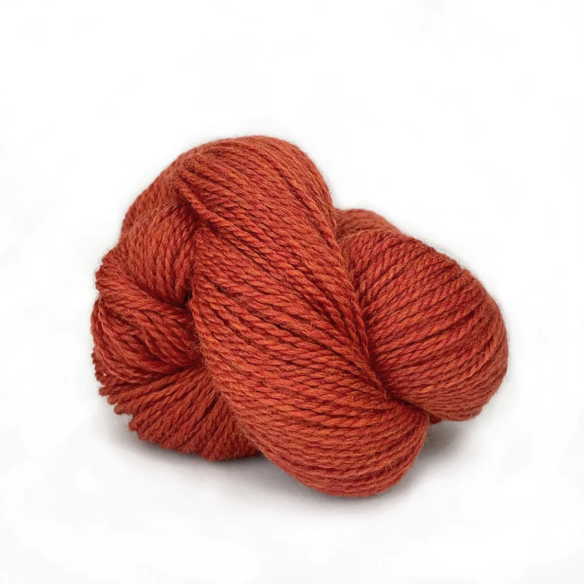 A skein of Kelbourne Woolens Scout Burnt Orange Heather 805, a heathered rusty orange with yellow