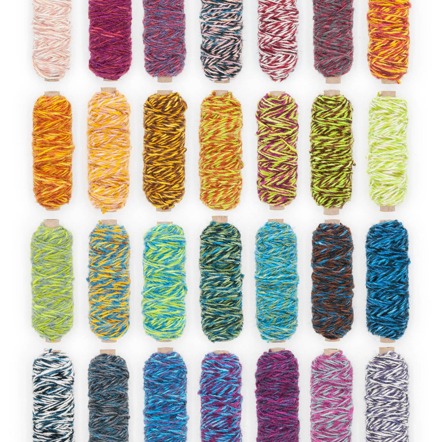 A variety of Plied Yarn bobbins in different color ways 