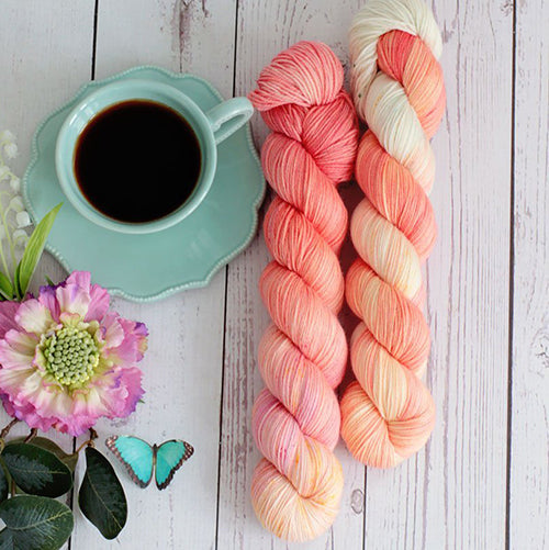 Yarn Love Amy March in Living Coral a gradient yarn in peach, coral, pink and white color.