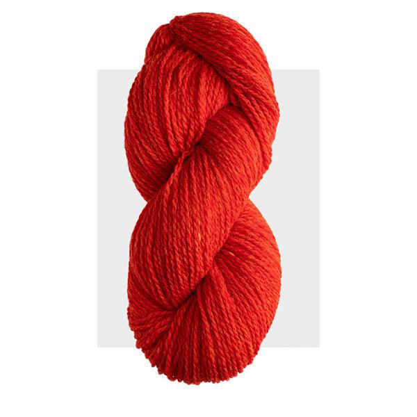 Skein of Harrisville Highland Poppy, a dark reddish orange.