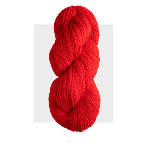 Skein of Harrisville Highland Scarlet, a bright orangey red.