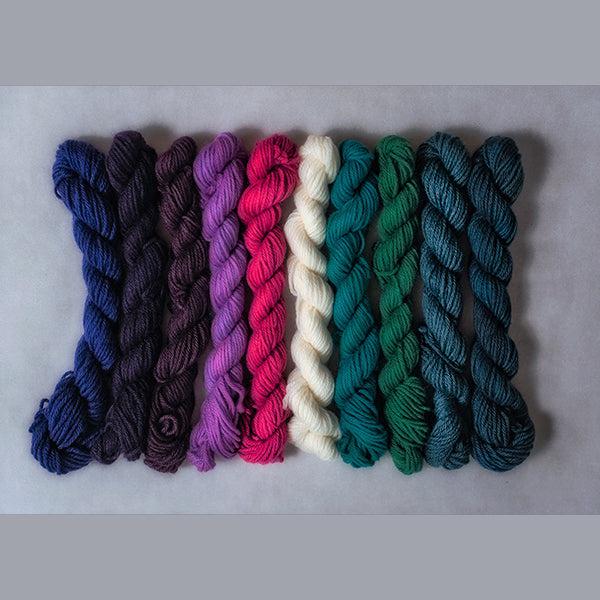 10 mini skeins of Jade Sapphire Coloring Box Bridget&#39;s Delight- and pattern booklet in shades of purple, green, teal, pink and natural.