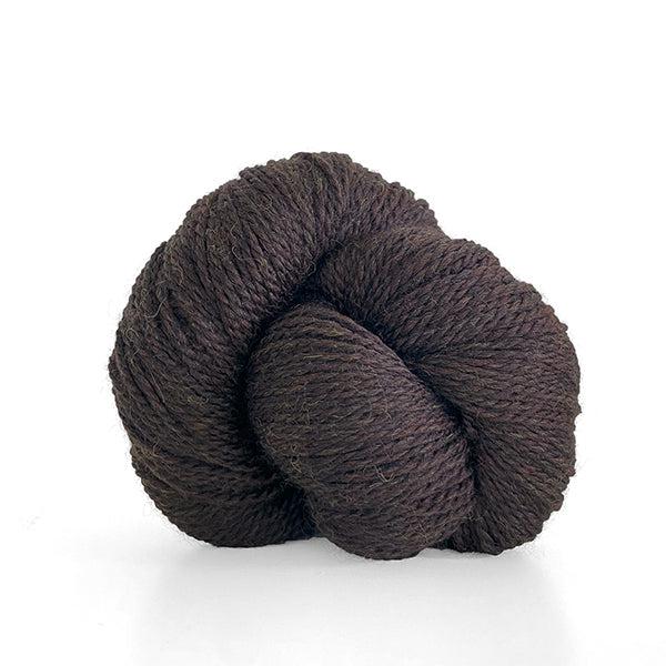 A skein of Kelbourne Woolens Scout Chestnut Heather 205, a heathered chocolate brown.