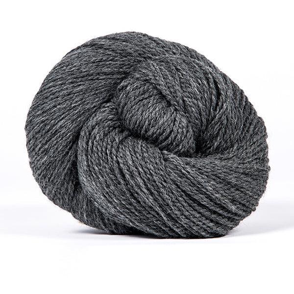 A skein of Kelbourne Woolens Scout Graphite Heather 034, a heatherwed dark grey.