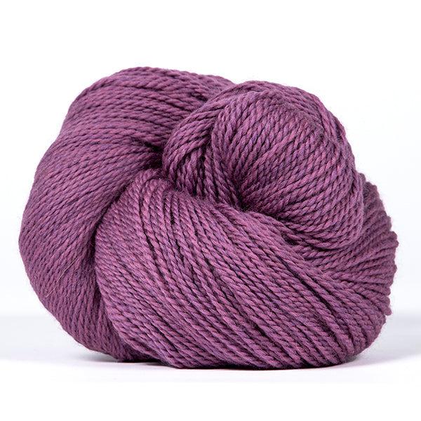 A skein of Kelbourne Woolens Scout Orchid Heather 519, a heathered medium pinkish purple.