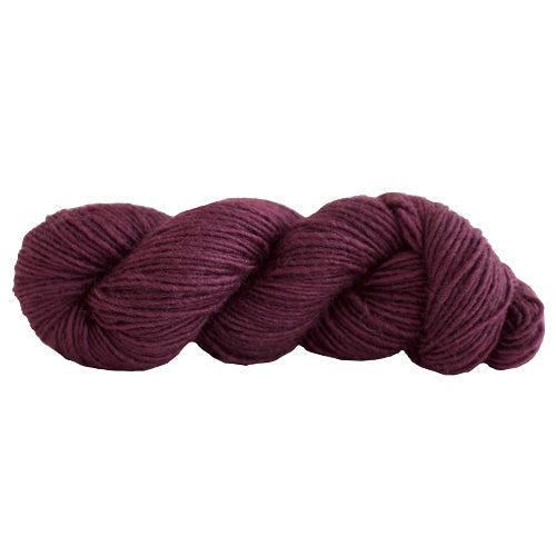 A skein of Manos Silk Blend Bing Cherry 300M, a dark brownish red.