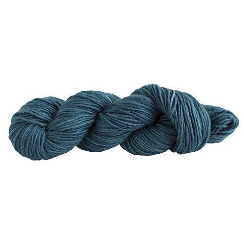 A skein of Manos Silk Blend Mallard 3036, a dark teal.