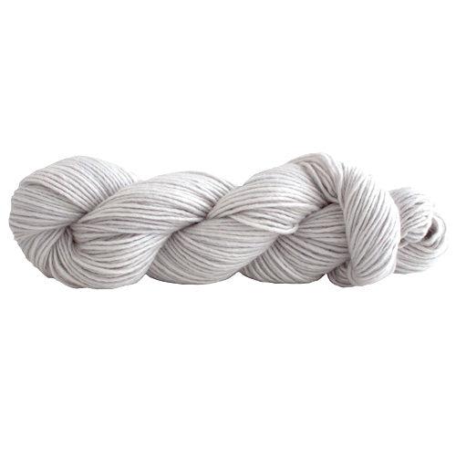 A skein of Manos Silk Blend Silver 3218, a light grey.